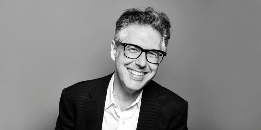 A black and white photograph of Ira Glass